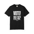 Black t-shirt with white text 'VOTE! WHILE YOU'RE STILL FREE' on a white background